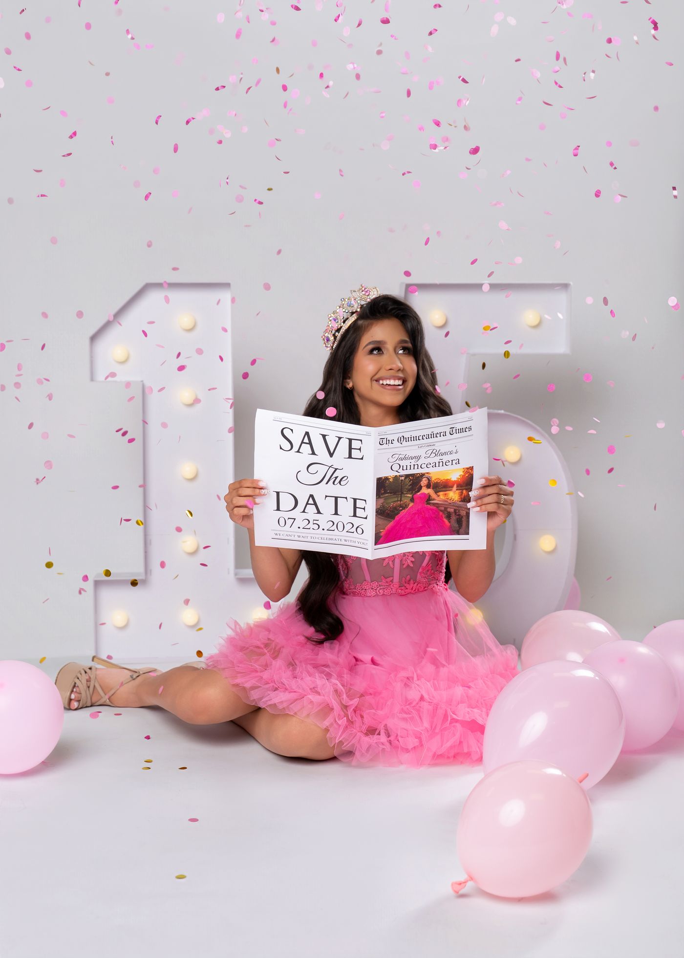 Quinceañera reading a save-the-date newspaper with pink confetti